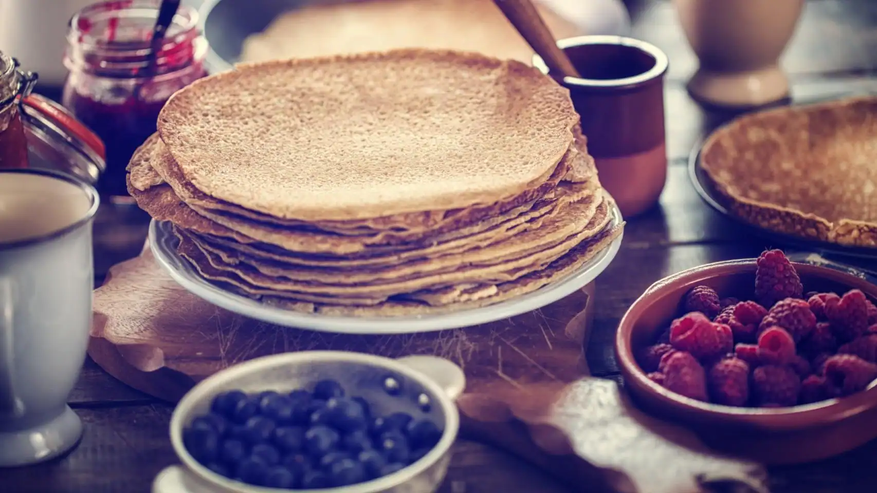 healthy crepes with fresh berries and syrup breakfast meal